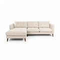 **Moderne beige hoekbank met slanke poten**